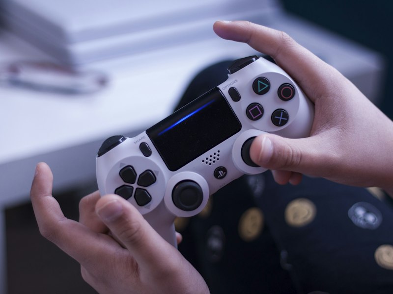 A desk of open tomes and controllers